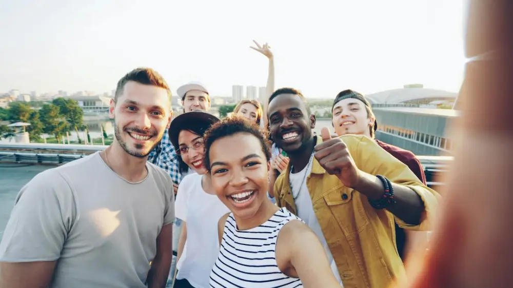 A diverse group of friends taking a selfie outdoors, illustrating collective action